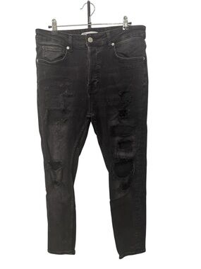 Zara distressed button fly black denim jeans featuring heavy rips size 32
